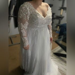 White wedding dress size 18. As is from boutique/no alterations done.